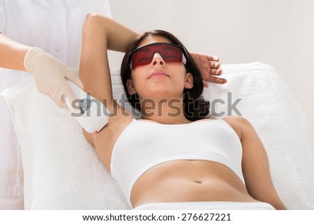 Woman Receiving Epilation Laser Treatment On Armpit At Beauty Clinic