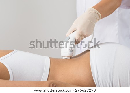 Close-up Of Woman Lying Receiving Epilation Laser Treatment On Back