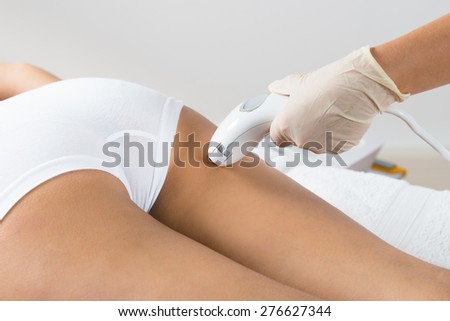Close-up Of Woman Lying Receiving Epilation Laser Treatment On Buttock
