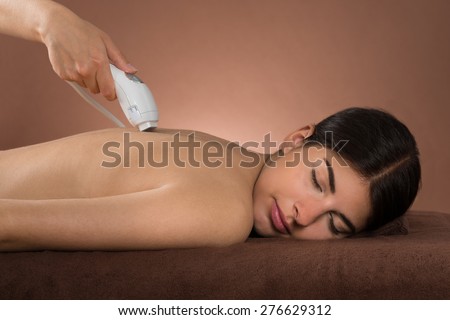 Close-up Of Young Woman With Eyes Closed Receiving Epilation Laser Treatment