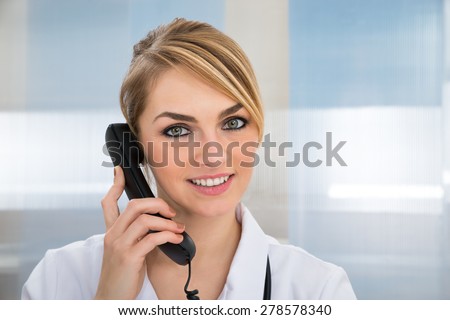 Close-up Of Happy Female Doctor Talking On Telephone