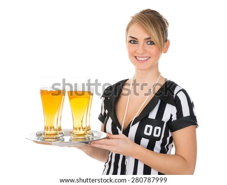 Young Female Referee Holding Tray With Glass Of Beer Over White Background