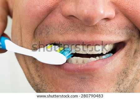 Close-up Photo Of A Man Brushing Teeth