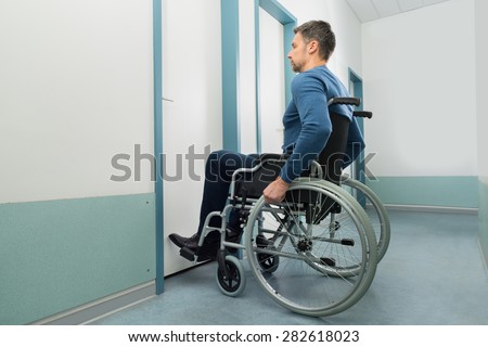 Disabled Man On Wheelchair Entering In Room