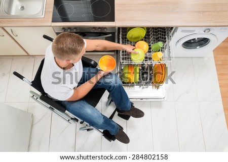 High Angle View Of Young Disabled Man In Kitchen