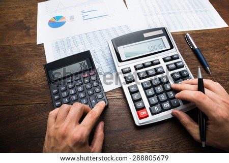 Businessman Analyzing Graph And Doing Financial Calculations
