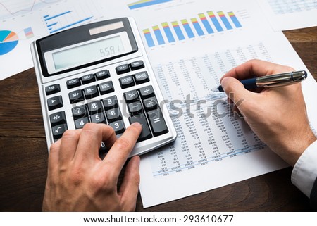 Businessman Analyzing Graph And Doing Financial Calculations
