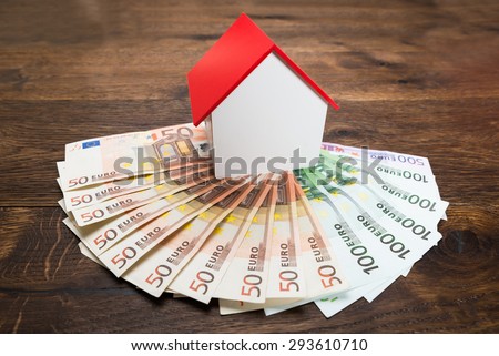 Close-up Of A House Model Kept On Euro Banknotes On Desk