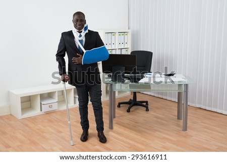 Portrait Of Happy Disabled African Businessman Standing In Office