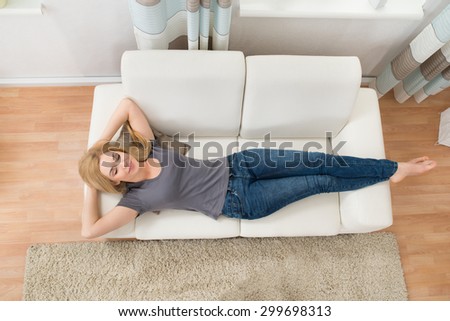 Young Beautiful Woman Sleeping On Sofa At Home