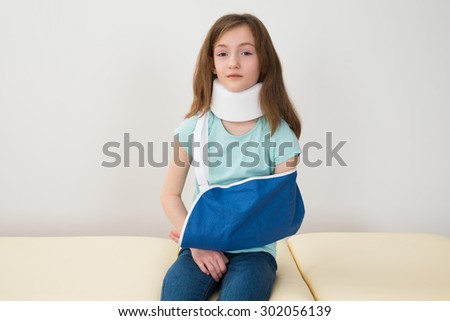 Portrait Of Girl Wearing Neck Brace And Arm Sling