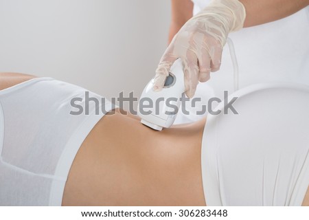 Young Woman Getting Epilation Laser Treatment At Beauty Center
