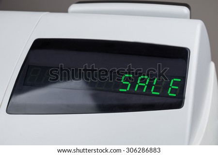 Close-up Of Cash Register With The Word Sale On The Electronic Display