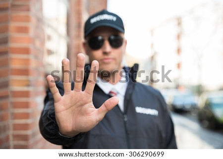 Male Security Guard Making Stop Sign With Hands