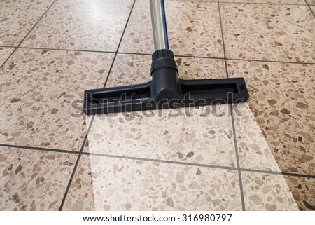 Close-up Of Vacuum Cleaner Over Cleaned Floor