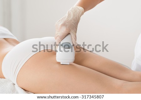 Close-up Of Woman Lying And Receiving Laser Hair Removal Treatment