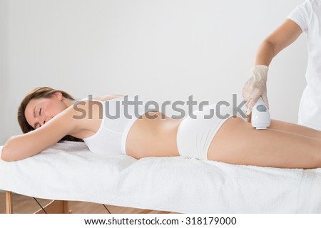Close-up Of Woman Lying And Receiving Laser Hair Removal Treatment