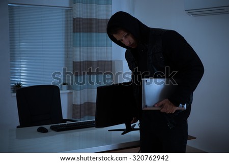Thief Stealing Computer And Laptop From Office