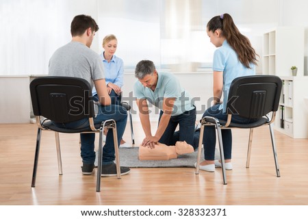 Male Instructor Teaching First Aid Cpr Technique To His Students