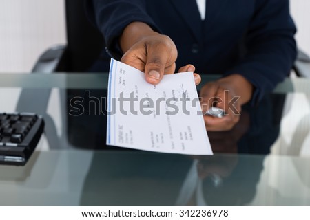 Close-up Photo Of Person\'s Hand Giving Cheque