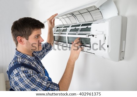 Photo Of Young Male Technician Repairing Air Conditioner