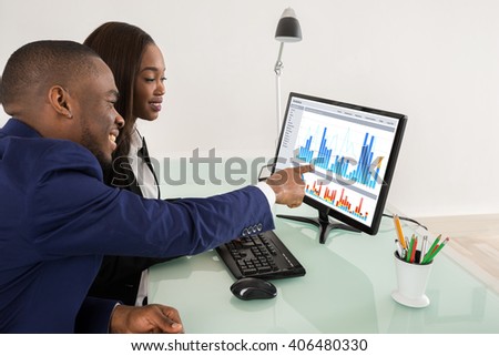 African American Business Man And Woman Showing Their Successful Teamwork On Computer