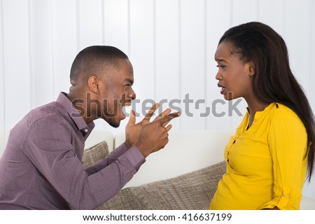 Angry Young African Man Screaming At Woman