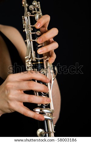 Women playing on clarinet. Hands closeup