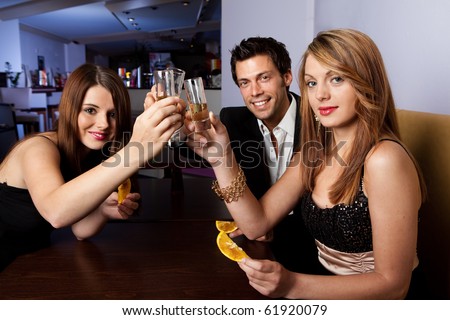 Group of friends together having fun. Focus on glasses