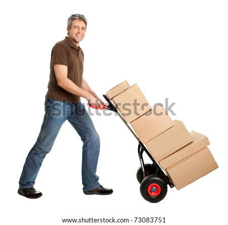 Delivery man pushing hand truck and stack of boxes