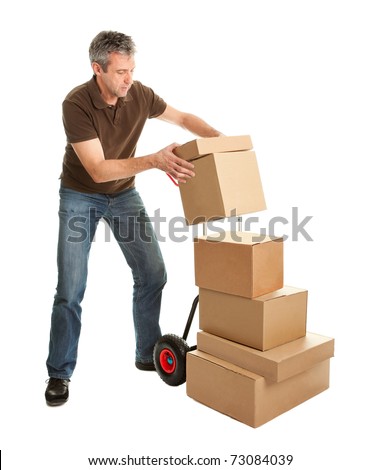 Delivery man staking packages on hand truck