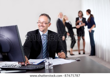 Portrait of a group of mature entrepreneur in meeting at the office with laptop - Showing thumbs up