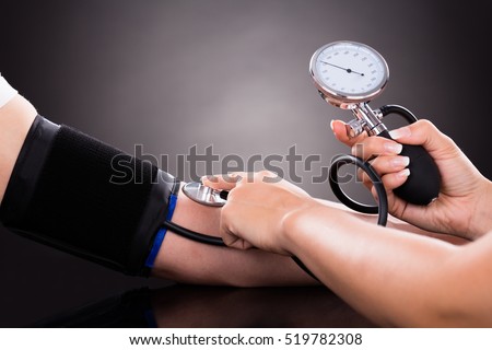 Close-up Of A Doctor Checking Blood Pressure O Patient