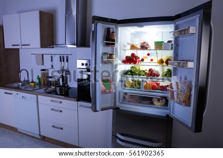 Open Refrigerator Full Of Healthy Items In Modern Kitchen