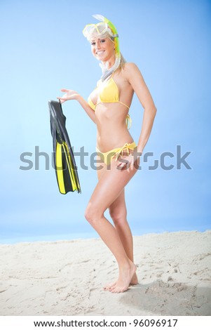 Beautiful young woman in bikini with snorkel equipment at the beach