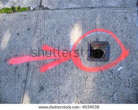 an abstract painting is formed by directions painted on the sidewalk for construction repairs