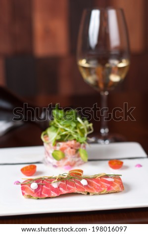 smoked salmon in two different ways on a white dish