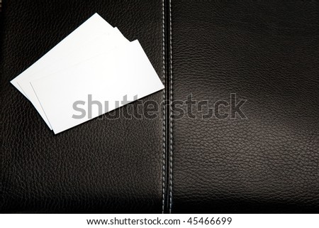 Business cards on a leather briefcase. Isolated on white.