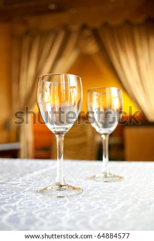 Wine glasses are on the table in the elegant restaurant