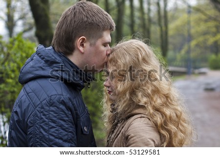 couple forehead kissing outdoors in spring