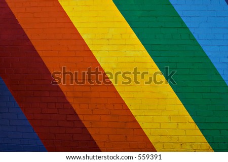 Brick building face painted with rainbow