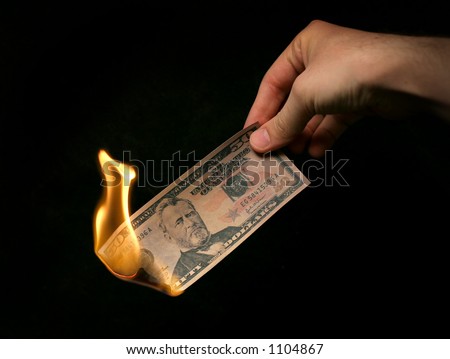 Money To Burn! A hand holding a Fifty Dollar Bill on fire.