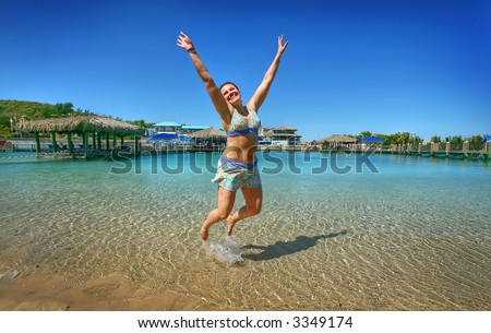 Woman jumping in the water - ocean