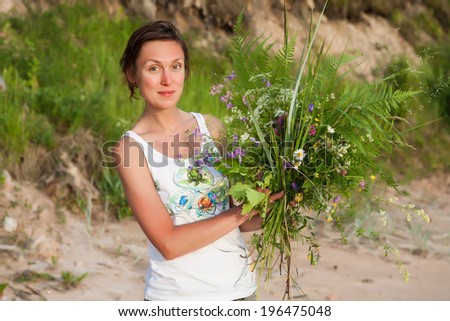Beautiful Girl with summer bouquet. Meeting solstice and Midsummer holiday.