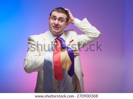 Man in white suit with three colored ties. Vivid emotions. Crazy.