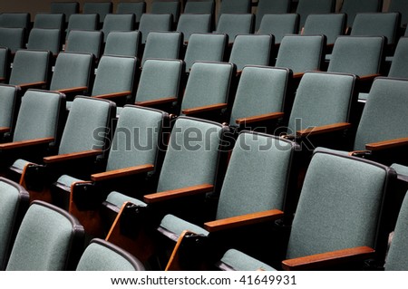 Rows of unoccupied seats in an empty auditorium or lecture hall
