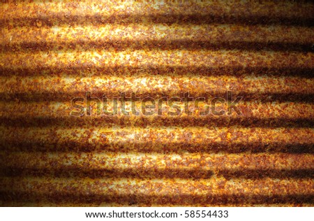 Closeup of rusty corrugated metal can surface lit diagonally