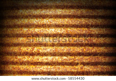 Rusty corrugated metal can surface lit dramatically from above