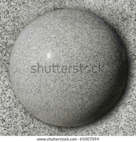 Polished stone sphere against smooth granite surface