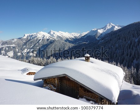 Log cabin in winter landscape